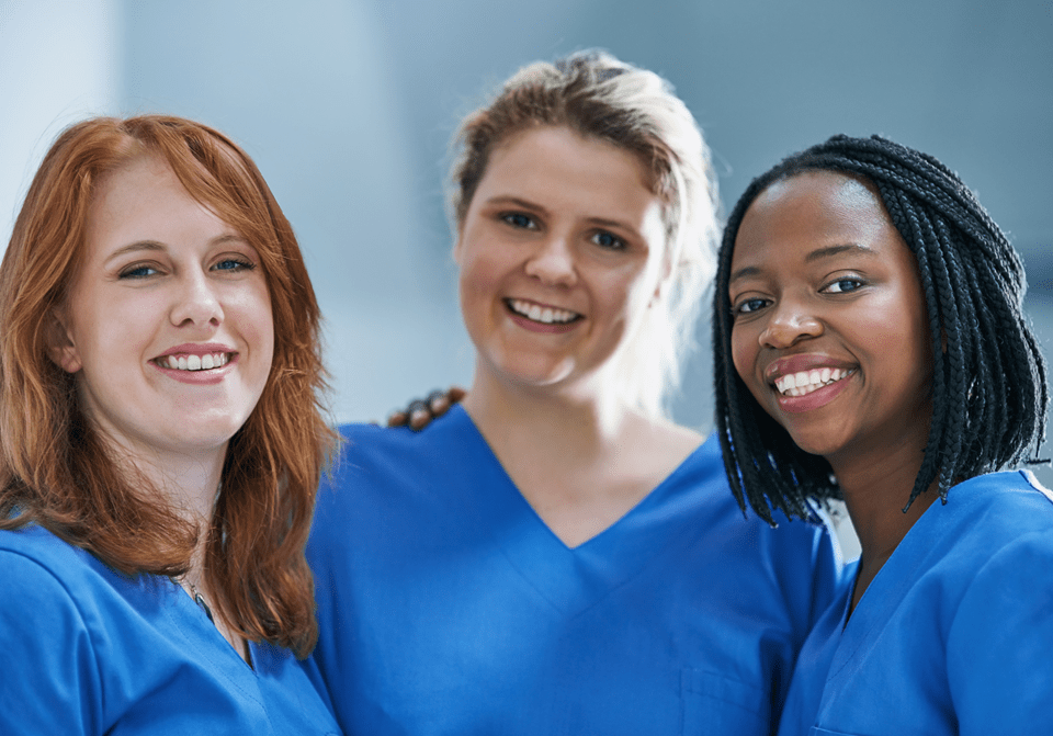 Three Female Caregivers Holding Shoulders