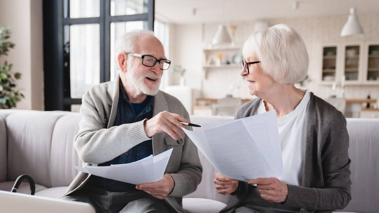 Elderly couple review paperwork for Medicare Part B